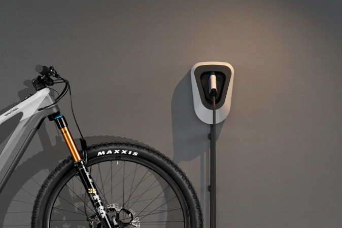 Rendering f&uuml;r die Designstudie Navitas: Ein E-Bike steht neben der Ladestation und wird geladen. Design von Squareone GmbH aus D&uuml;sseldorf.