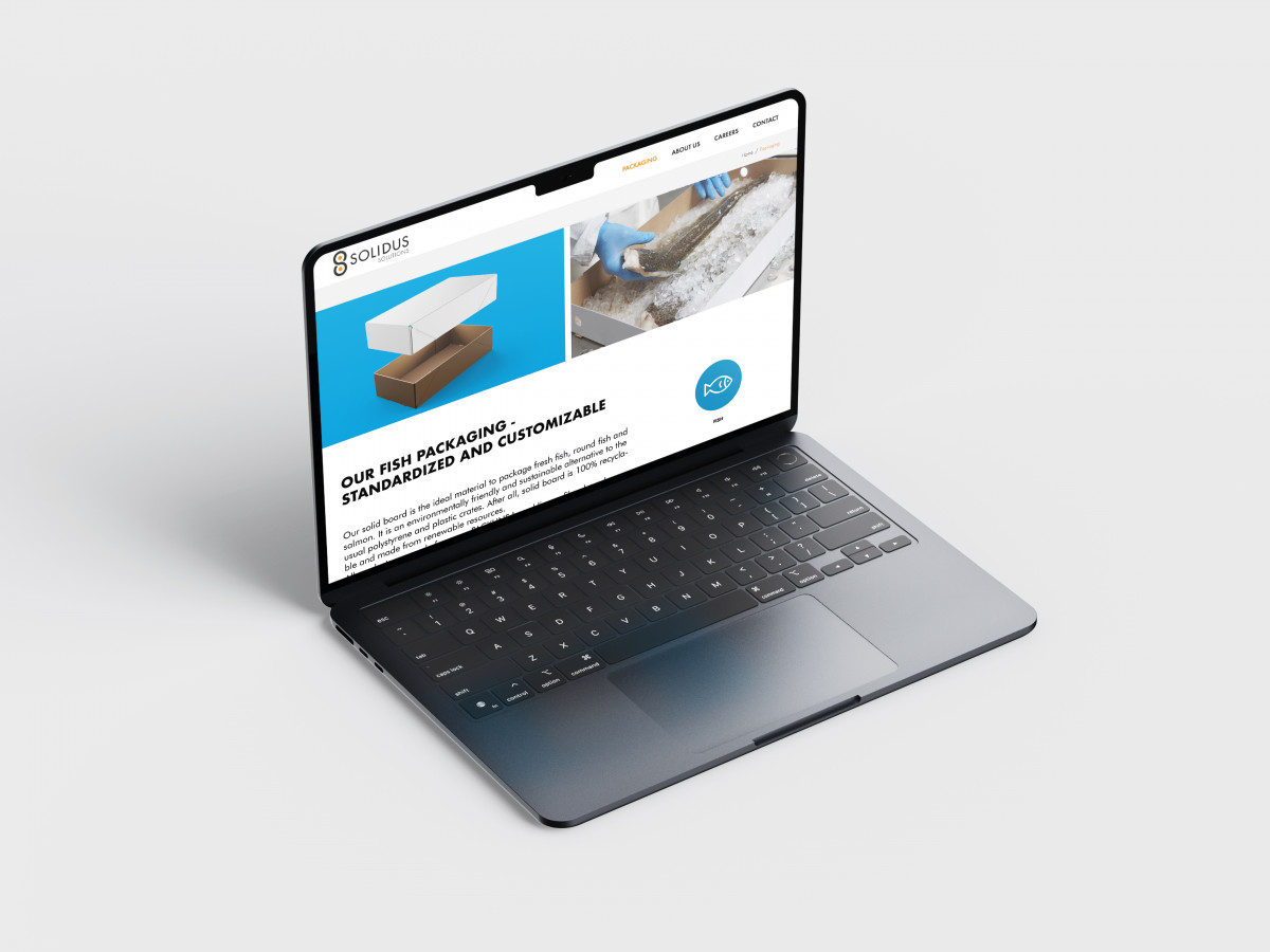 Perspective view of a Macbook displaying the newly designed Solidus Solutions website for fish packaging